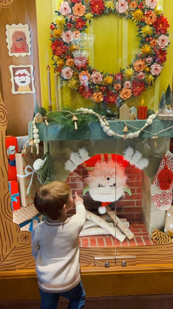 Toddler looks at Grand America Holiday Windows