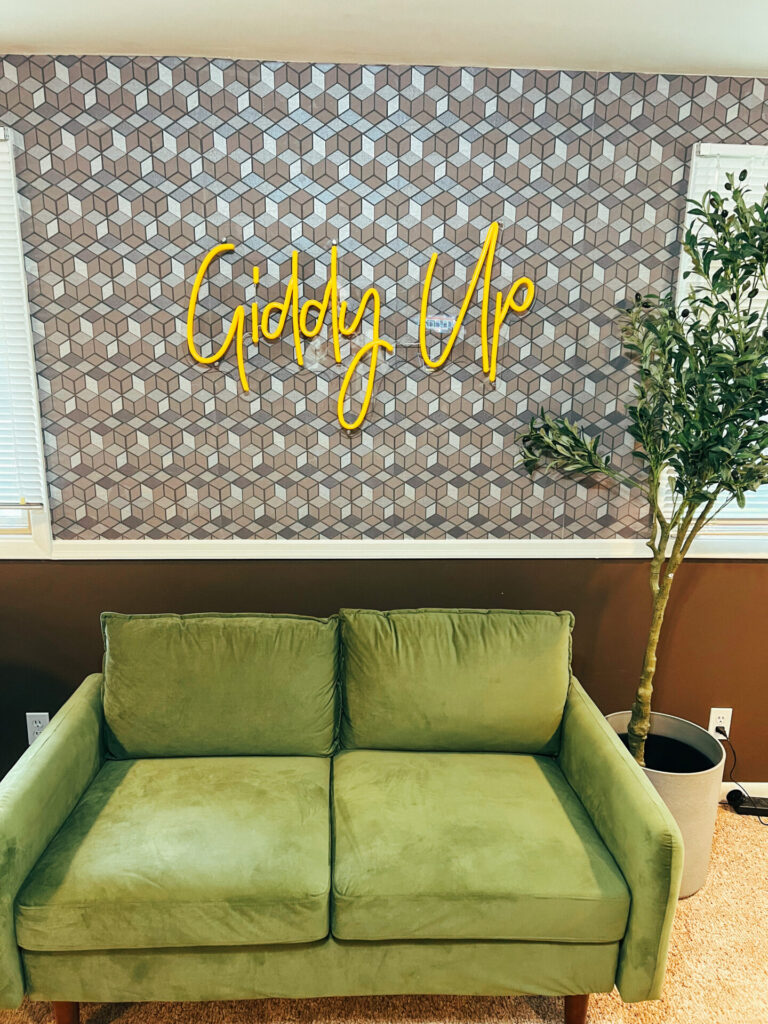 Giddy up sign above couch