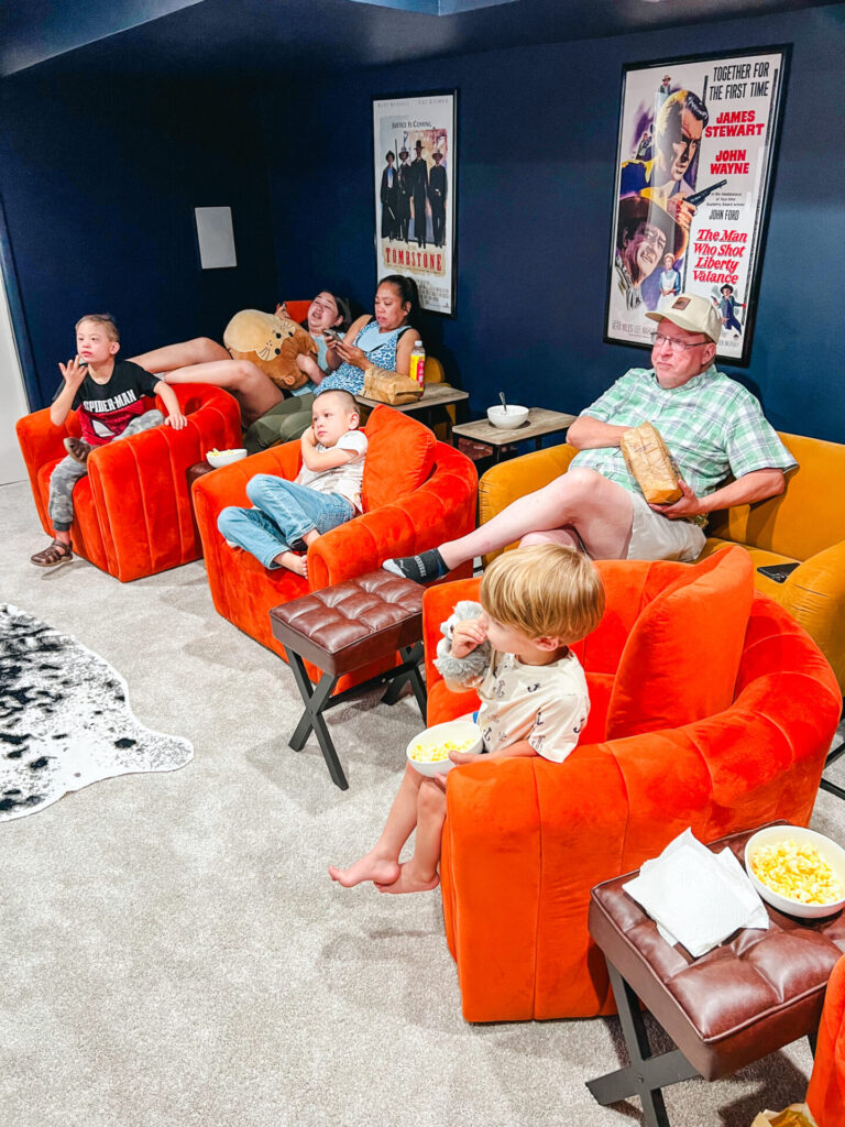 family watches movie in theatre room in Billings