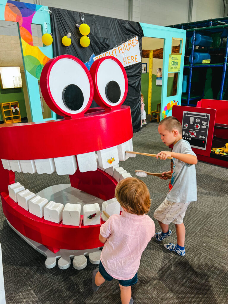 Kids playing with teeth exhibit at wise wonders in Billings